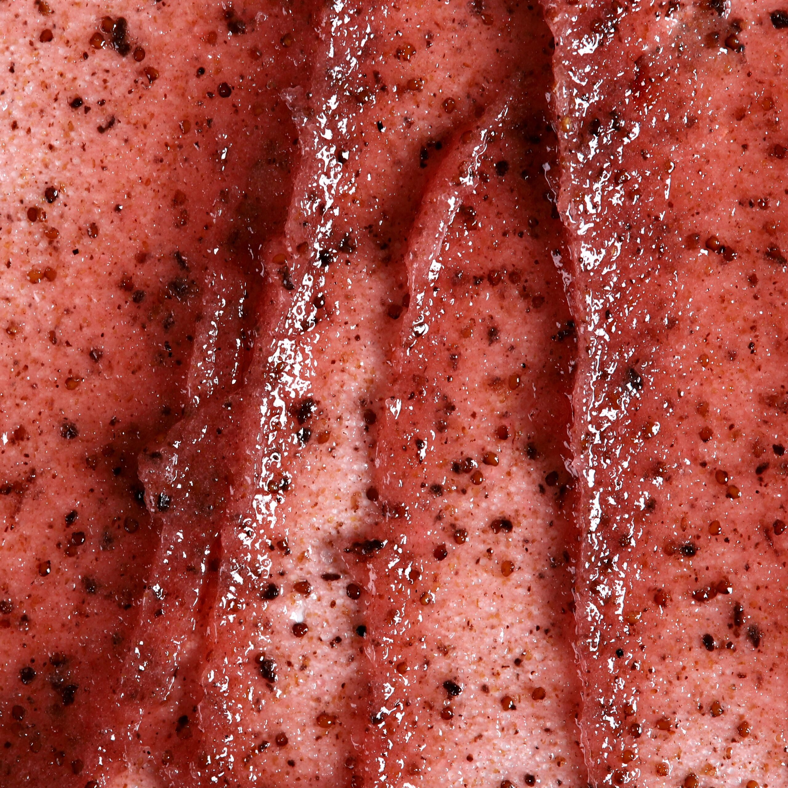 Granita body scrub texture with strawberry seeds.
