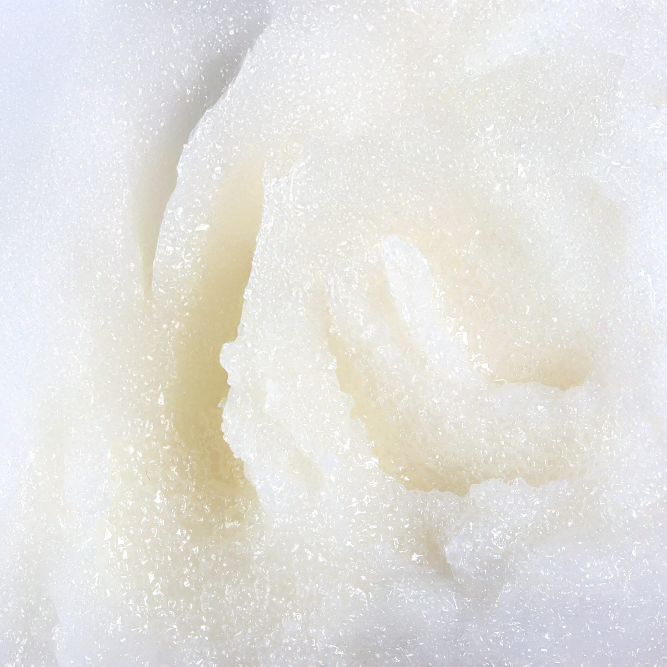 Granita body scrub texture with sugar, inspired by piña colada.