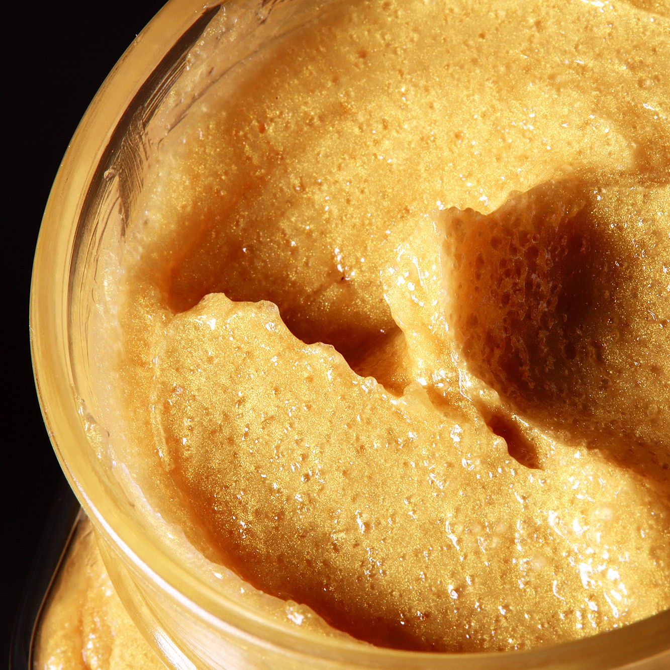 Gold granita body scrub texture with golden shimmer
